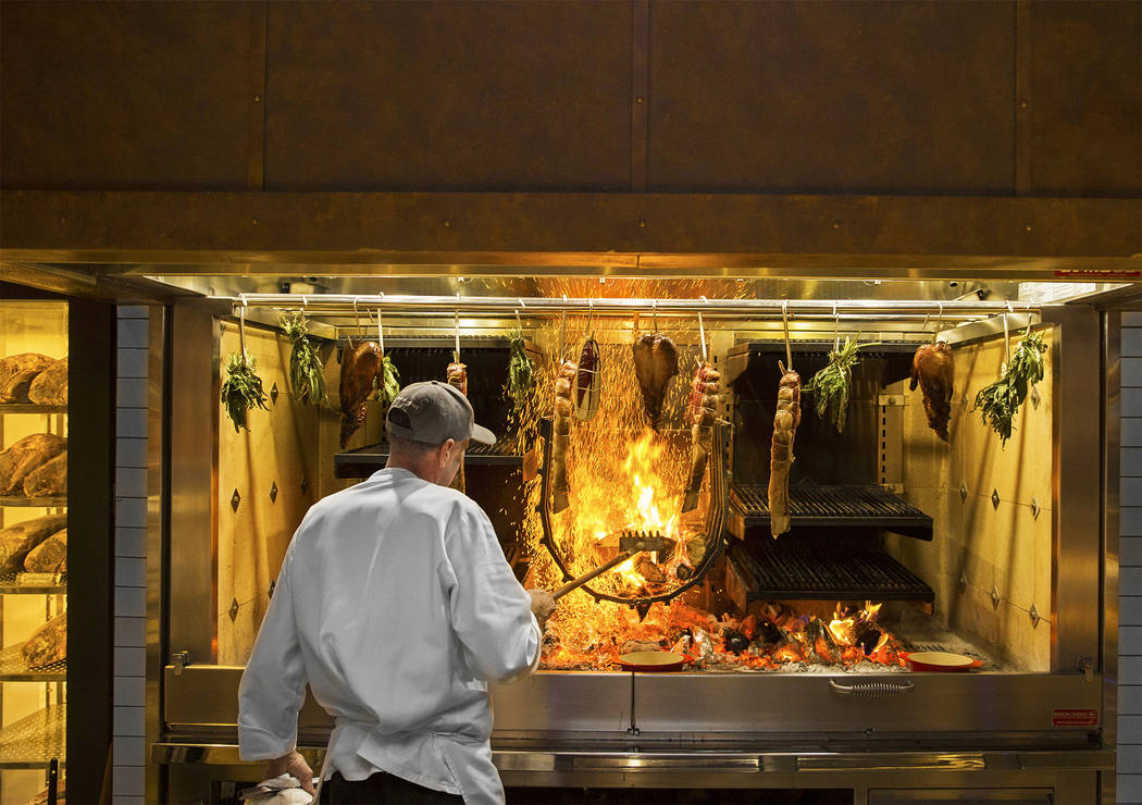 Master cook Scott Brown cooks on the open-hearth fire at Eataly on Wednesday, Feb. 6, 2019, at ...