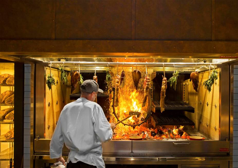Master cook Scott Brown cooks on the open-hearth fire at Eataly on Wednesday, Feb. 6, 2019, at ...