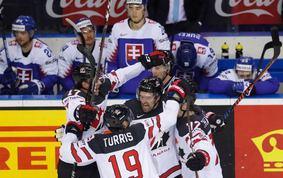 Canada's Mark Stone, center, celebrates with teammates after scoring his side's sixth goal duri ...