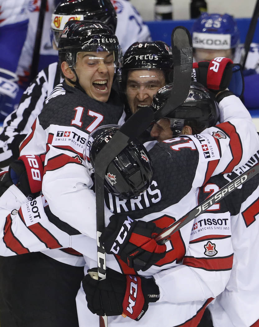 Canada's Mark Stone, center, celebrates with teammates after scoring his side's sixth goal duri ...