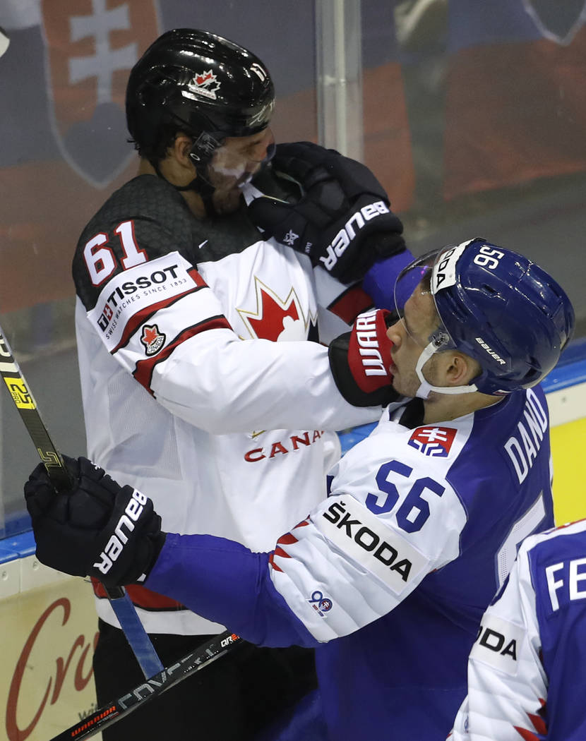 Slovakia's Marko Dano, right, punches Canada's Mark Stone, left, during the Ice Hockey World Ch ...