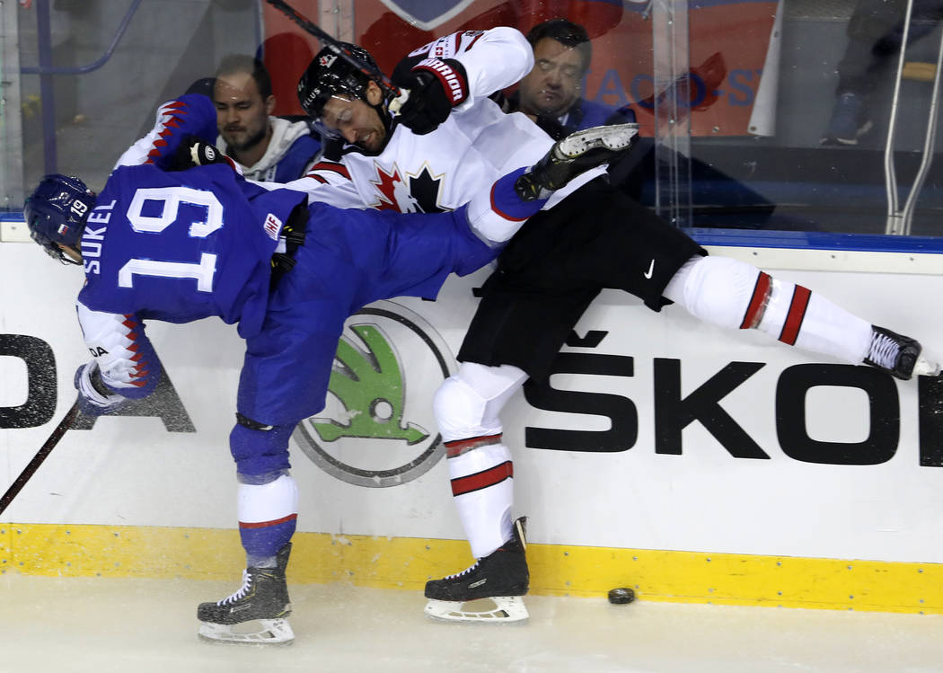 Slovakia's Matus Sukel, left, collides with Canada's Mark Stone, right, during the Ice Hockey W ...