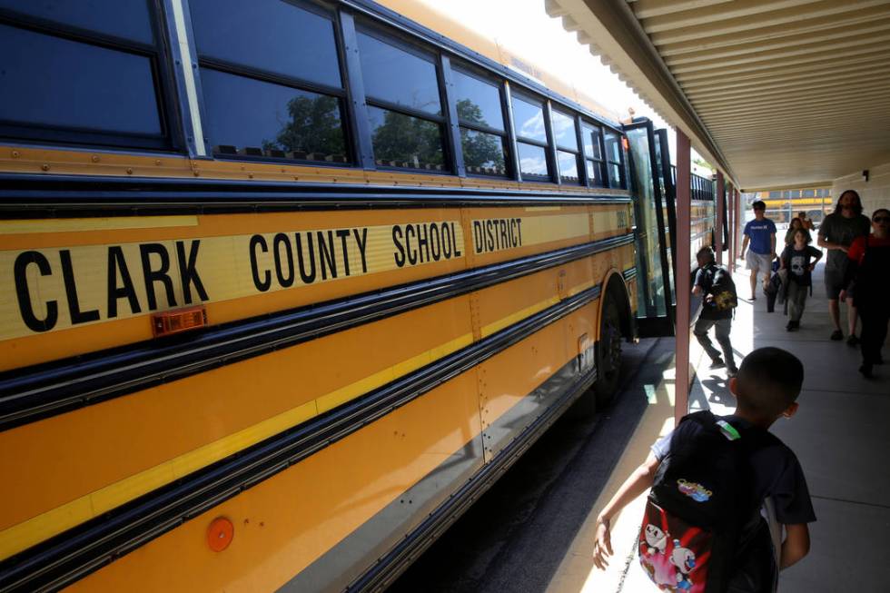 Students at Hoggard Elementary School in Las Vegas get on the bus Monday, May 13, 2019. (K.M. C ...