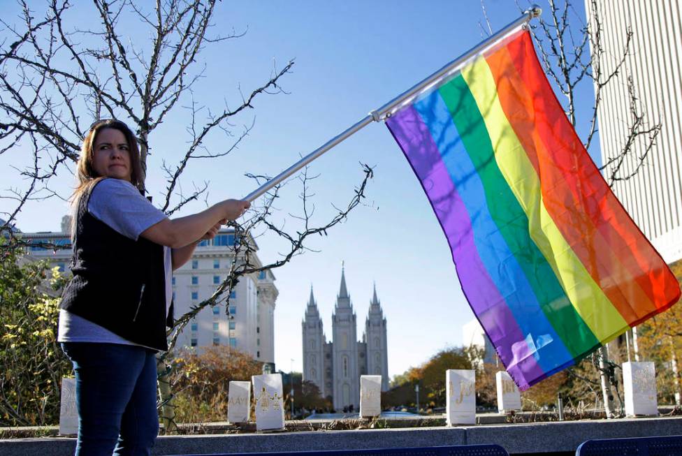 FILE - In this Nov. 14, 2015 file photo, Sandy Newcomb poses for a photograph with a rainbow fl ...