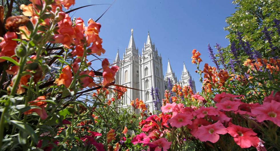 FILE - This Aug. 4, 2015 file photo, flowers bloom in front of the Salt Lake Temple, at Temple ...