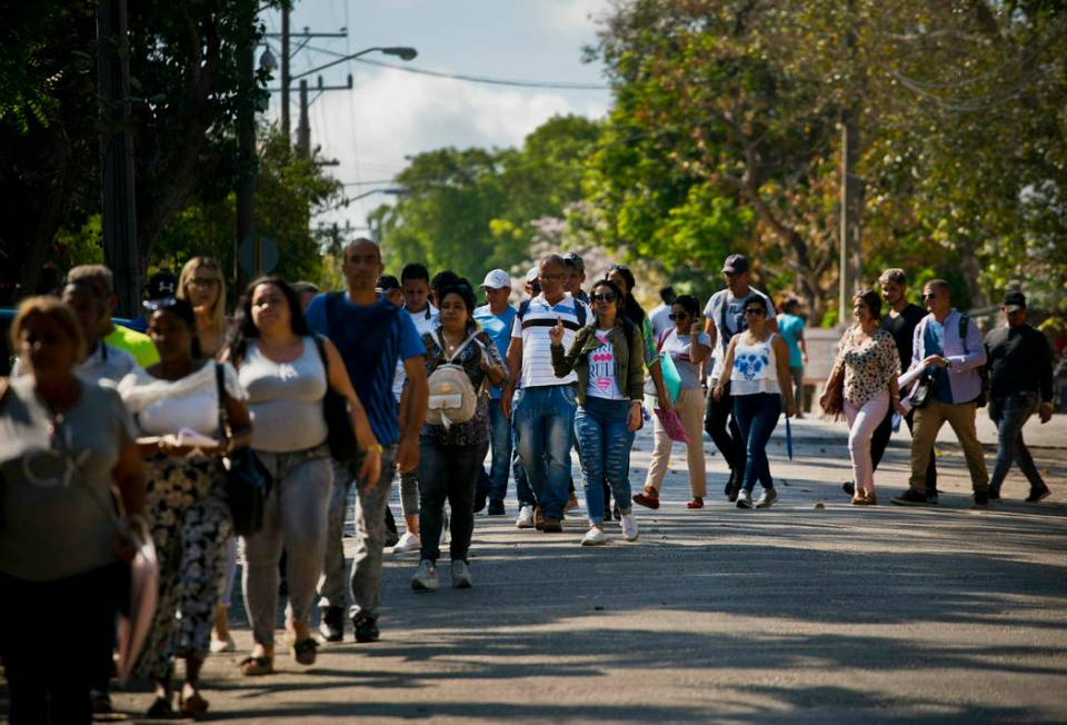 In this April 26, 2019, photo, Cubans wait their turn to enter Panama's embassy to apply for tr ...