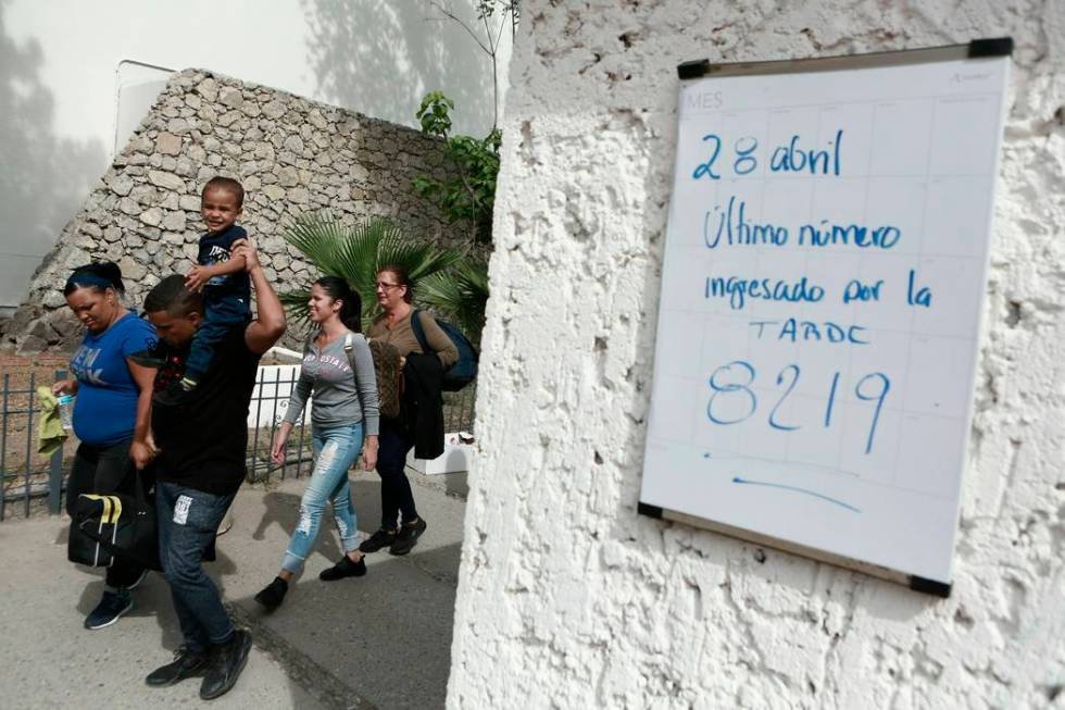 In this April 29, 2019 photo, Cuban migrants line up to be called by Mexican immigration offici ...