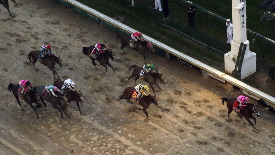 Luis Saez rides Maximum Security across the finish line first followed by Flavien Prat on Count ...