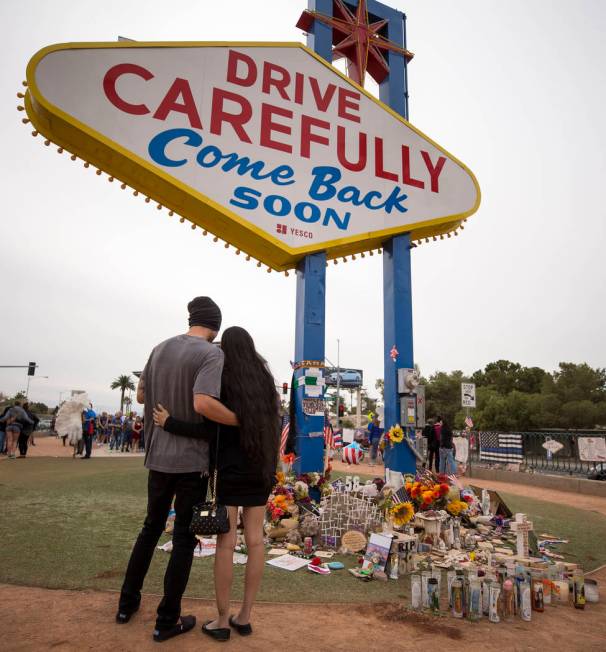 A couple embraces as they visit a memorial for the Route 91 Harvest shooting victims at the "We ...