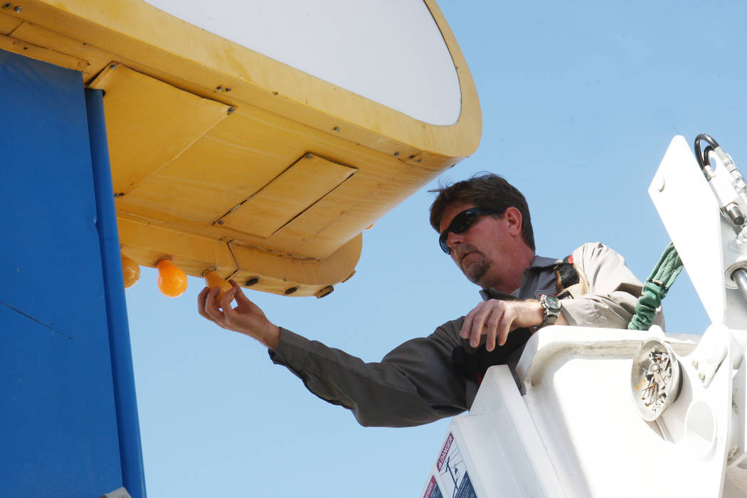 YESCO sign serviceman Kenny West changes out the bulbs on the iconic "Welcome to Fabulous Las V ...