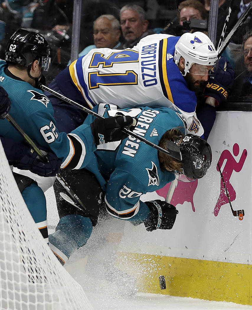 St. Louis Blues' Robert Bortuzzo (41) fights for the puck with San Jose Sharks' Kevin Labanc, l ...