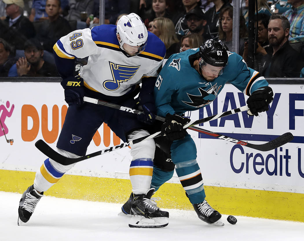 St. Louis Blues' Ivan Barbashev, left, and San Jose Sharks' Justin Braun fight for the puck dur ...