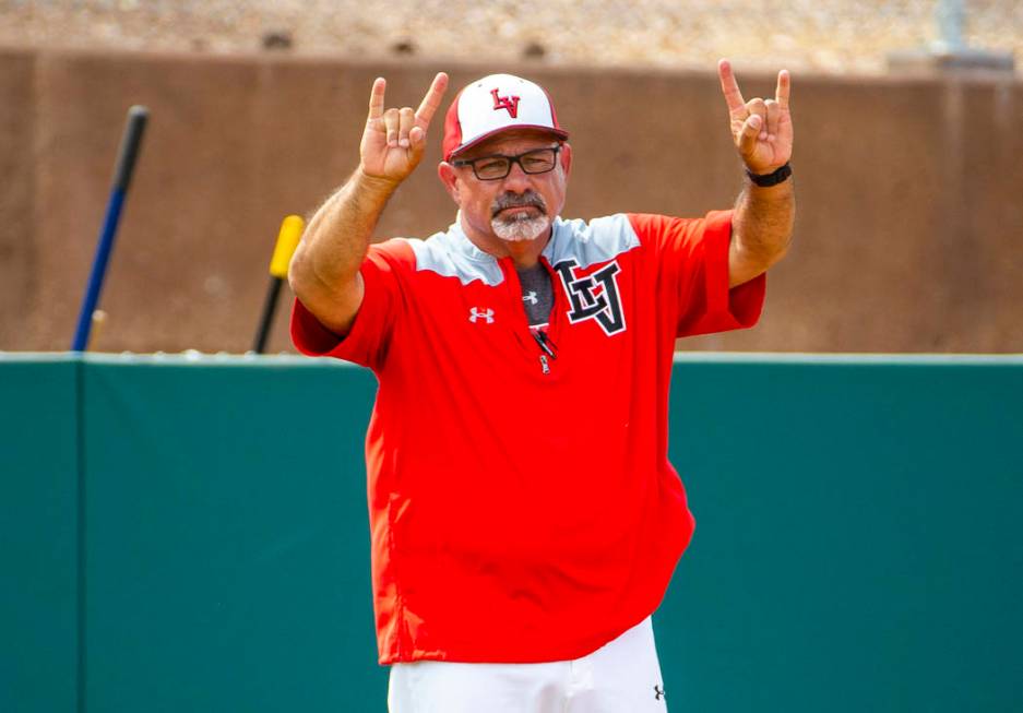 Longtime Las Vegas High coach Sam Thomas signals a player at first base during their state base ...