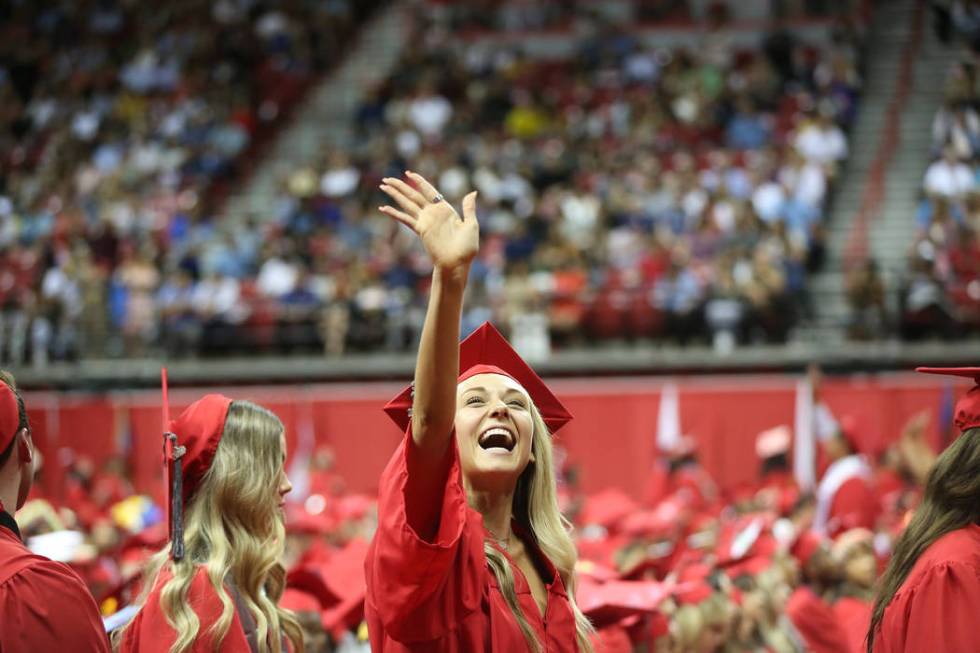 Communications major Alexandra Brianna Grady waves as she gets ready to walk the stage during t ...