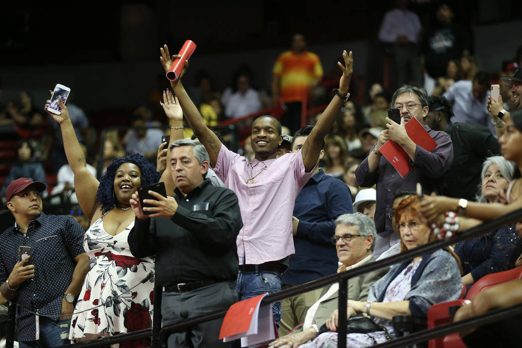 People wave at graduates during the UNLV commencement ceremony at the Thomas & Mack Center ...