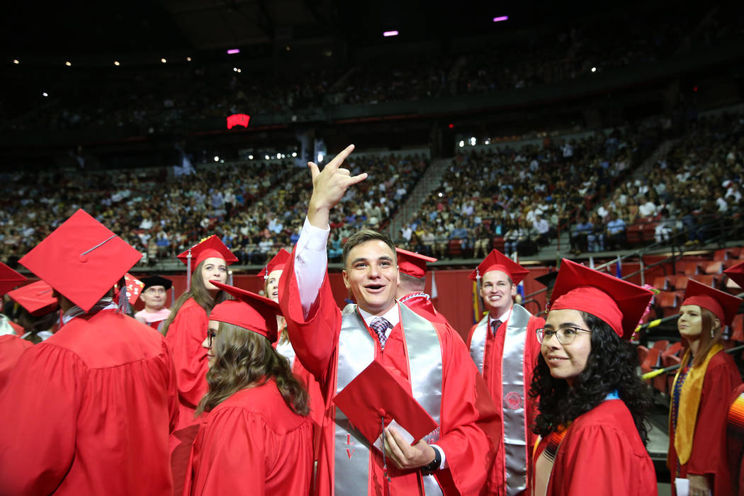 History major graduate Joseph Sanchez, center, 24, gestures to people in the crowd during the U ...