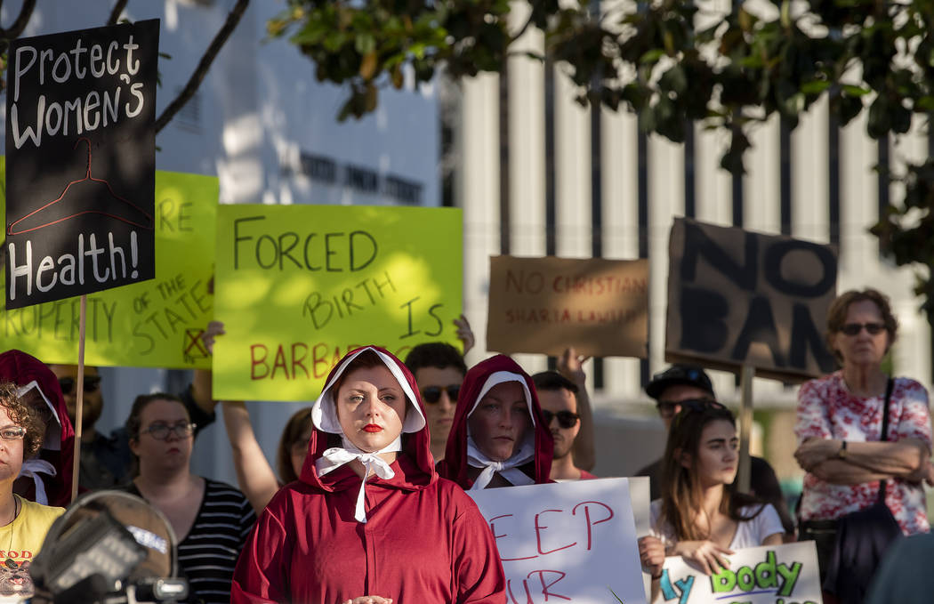 Margeaux Hartline, dressed as a handmaid, during a rally against HB314, the near-total ban on a ...