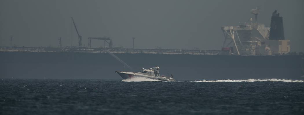 An Emirati coast guard vessel passes an oil tanker off the coast of Fujairah, United Arab Emira ...