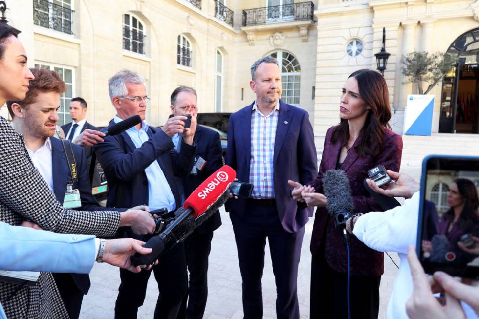 New Zealand Prime Minister Jacinda Ardern, right, gives a press conference, at the OECD headqua ...