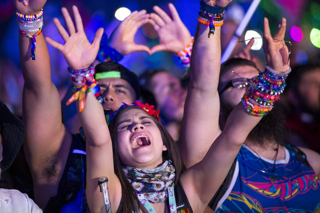 Festivalgoers dance to the sounds of American DJ Kaskade on day one of the Electric Daisy Carni ...