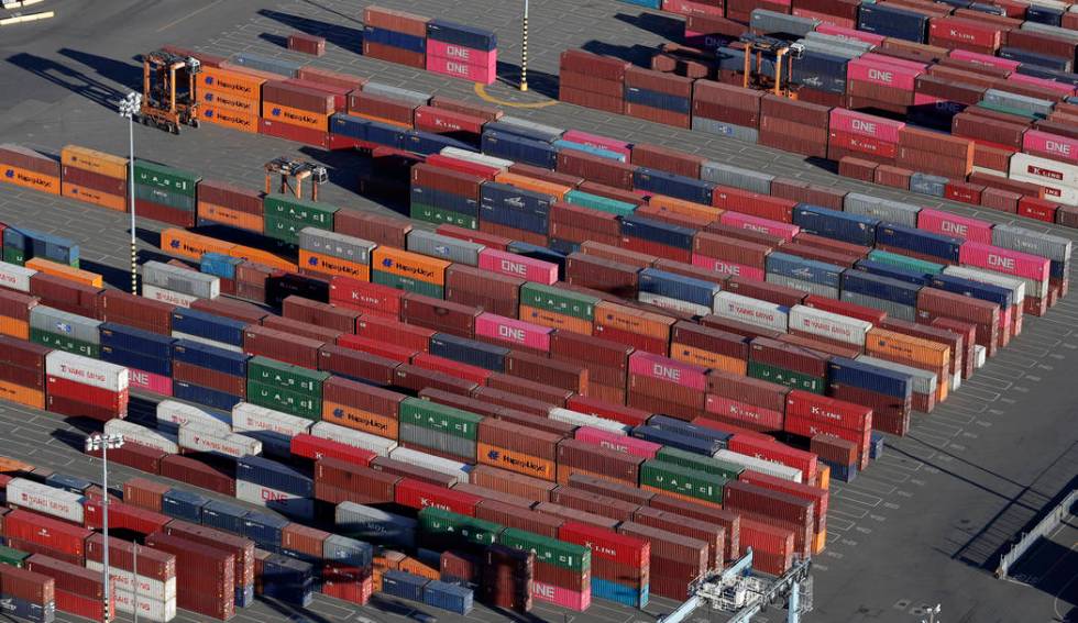FILE - In this March 5, 2019, file photo, cargo containers are staged near cranes at the Port o ...