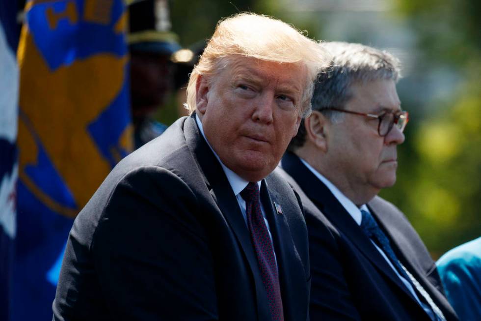 President Donald Trump sits with Attorney General William Barr during the 38th Annual National ...