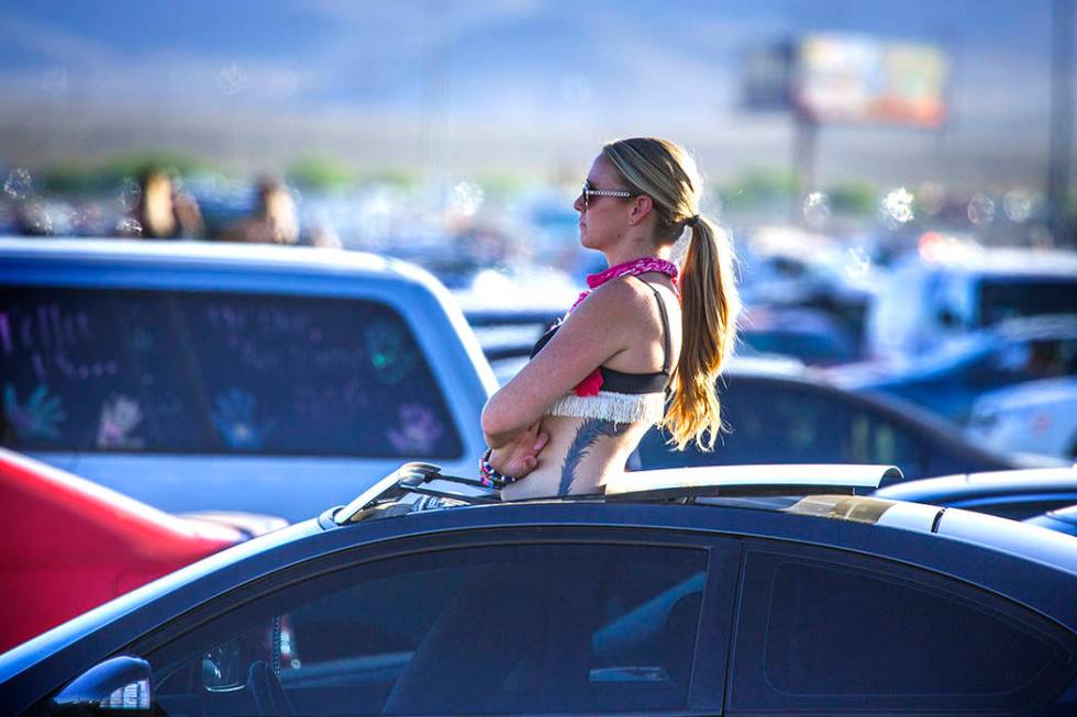 A fan waits for traffic to move in the Las Vegas Speedway parking lot after the Electric Daisy ...