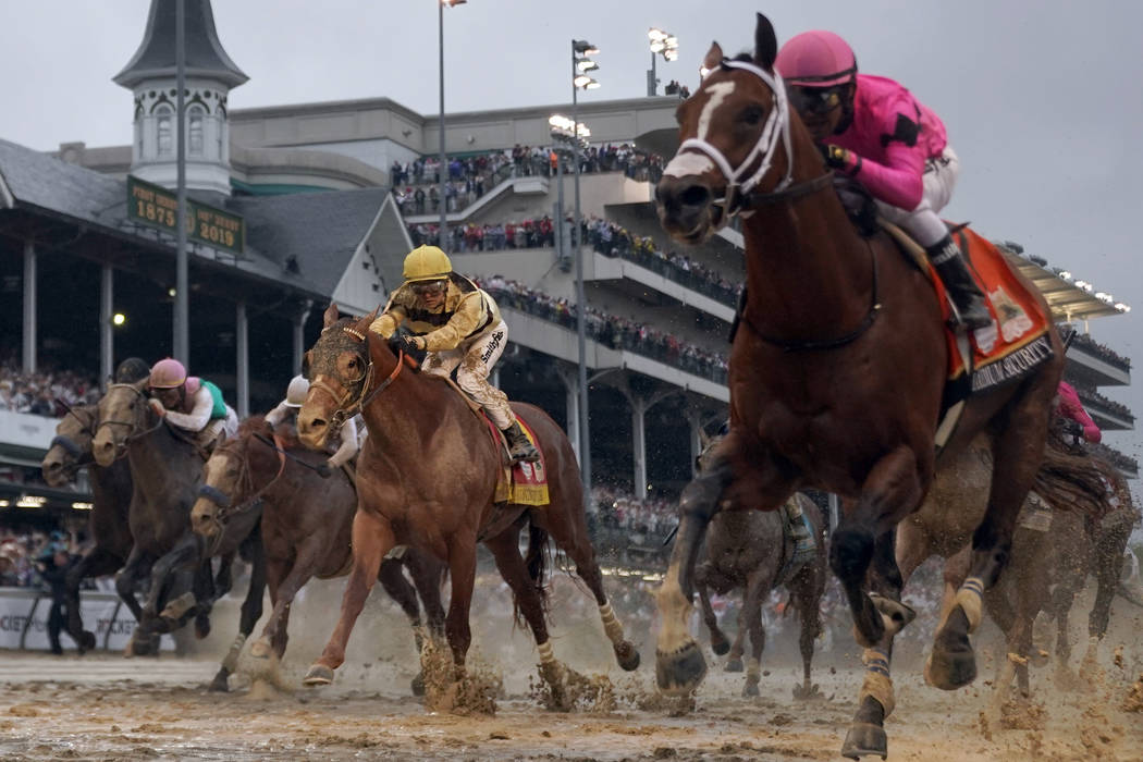 Luis Saez rides Maximum Security, right, across the finish line first against Flavien Prat on C ...