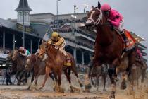 Luis Saez rides Maximum Security, right, across the finish line first against Flavien Prat on C ...