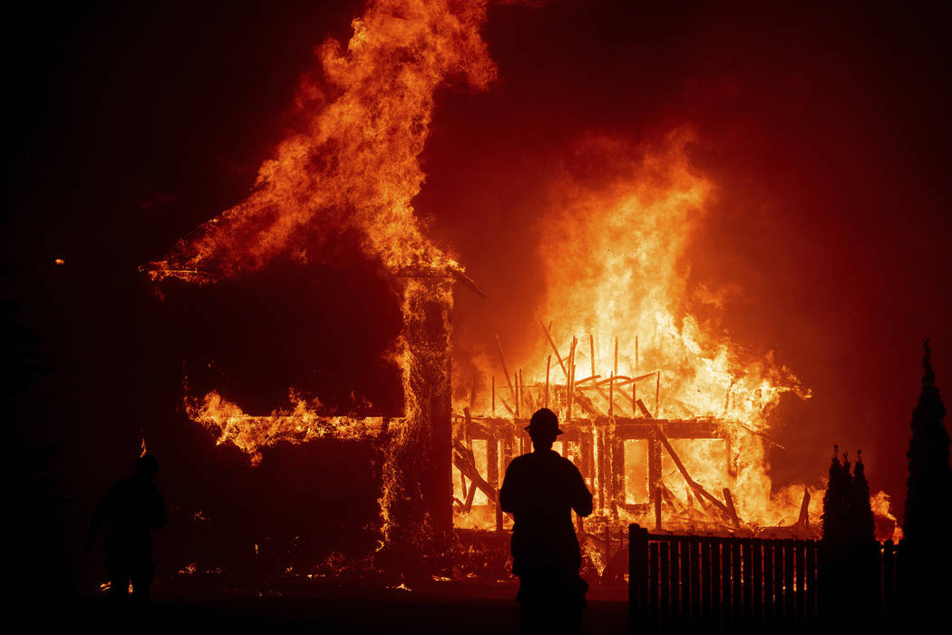 In this Thursday, Nov. 8, 2018 file photo, a home burns as the Camp Fire rages through Paradise ...