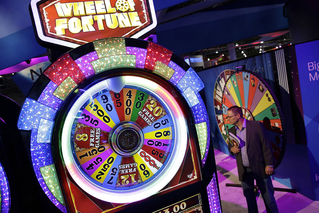 A Wheel of Fortune slot machine is seen at the IGT booth during the Global Gaming Expo in 2014 ...