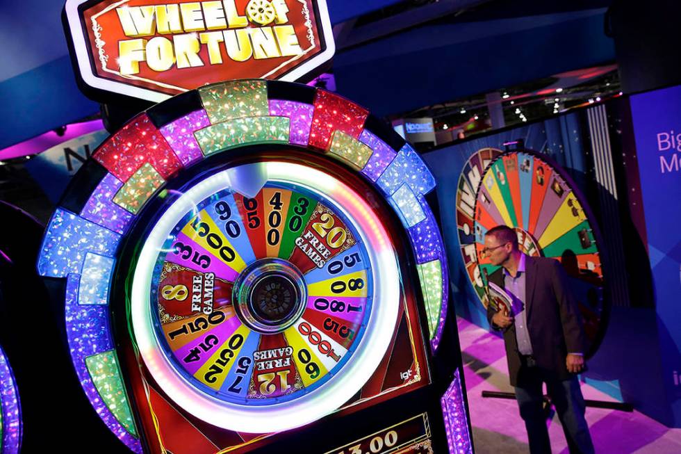 A Wheel of Fortune slot machine is seen at the IGT booth during the Global Gaming Expo in 2014 ...