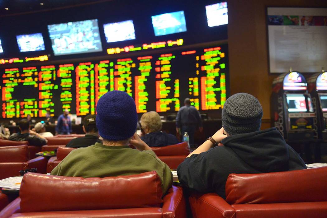 Gamblers sit in the sports book at Sunset Station casino in Henderson in 2015. (Las Vegas Revie ...