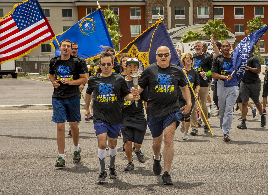 Nevada law enforcement officers and Special Olympics Nevada athletes make their way up Russell ...