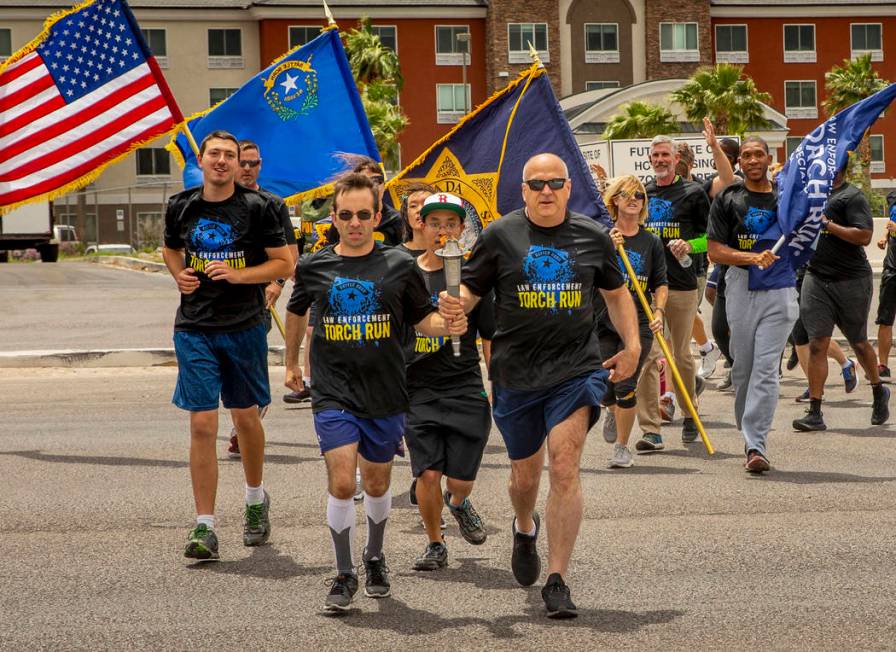 Nevada law enforcement officers and Special Olympics Nevada athletes make their way up Russell ...