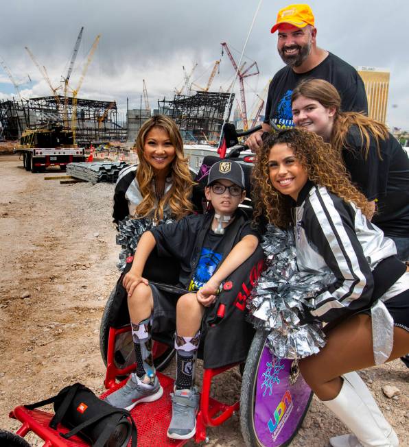 Blake Smith, center, is flanked by Raiderettes with his sister Aleah and dad Chad at the Raider ...