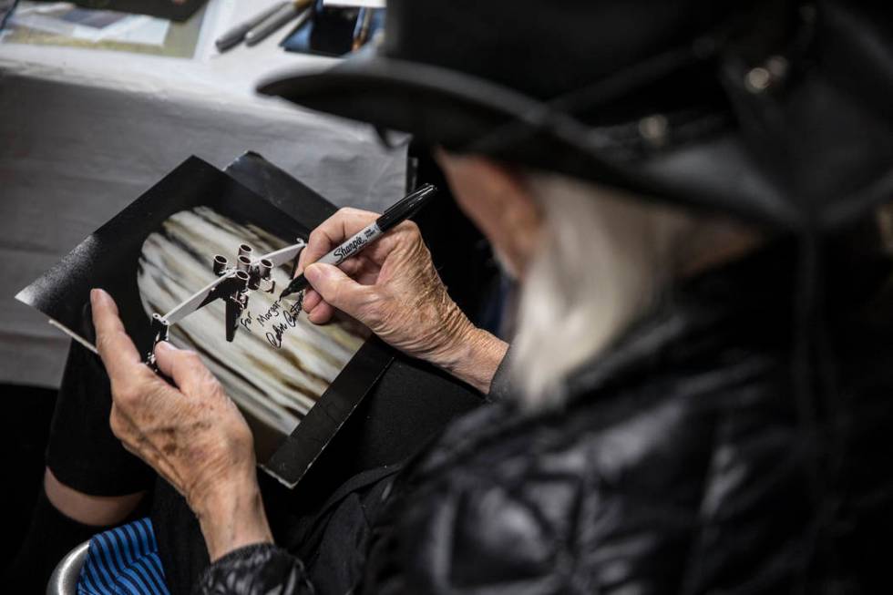 Colin Cantwell, concept artist and model builder for the original Star Wars movies, signs a pho ...