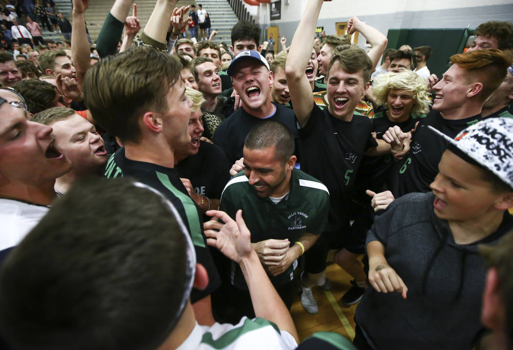 Palo Verde students and players celebrate their victory with head coach Phil Clarke, center, af ...
