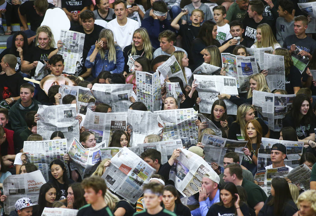 Palo Verde students hold up newspapers as Coronado players are introduced at the start of the C ...