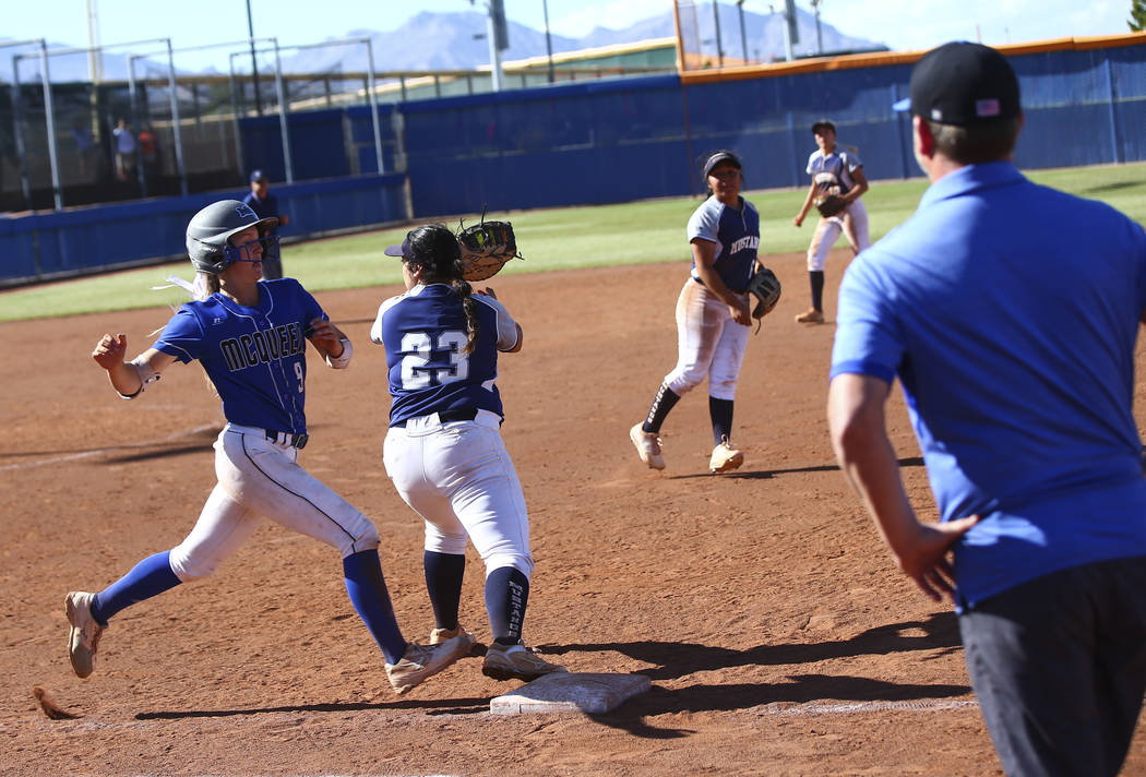 McQueen's Rylie Miller (9) gets tagged out by Shadow Ridge's Alexis Toia (23) during the second ...