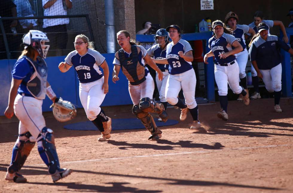 Shadow Ridge players celebrate a run by Alyssa Stanley, not pictured, during the second round o ...