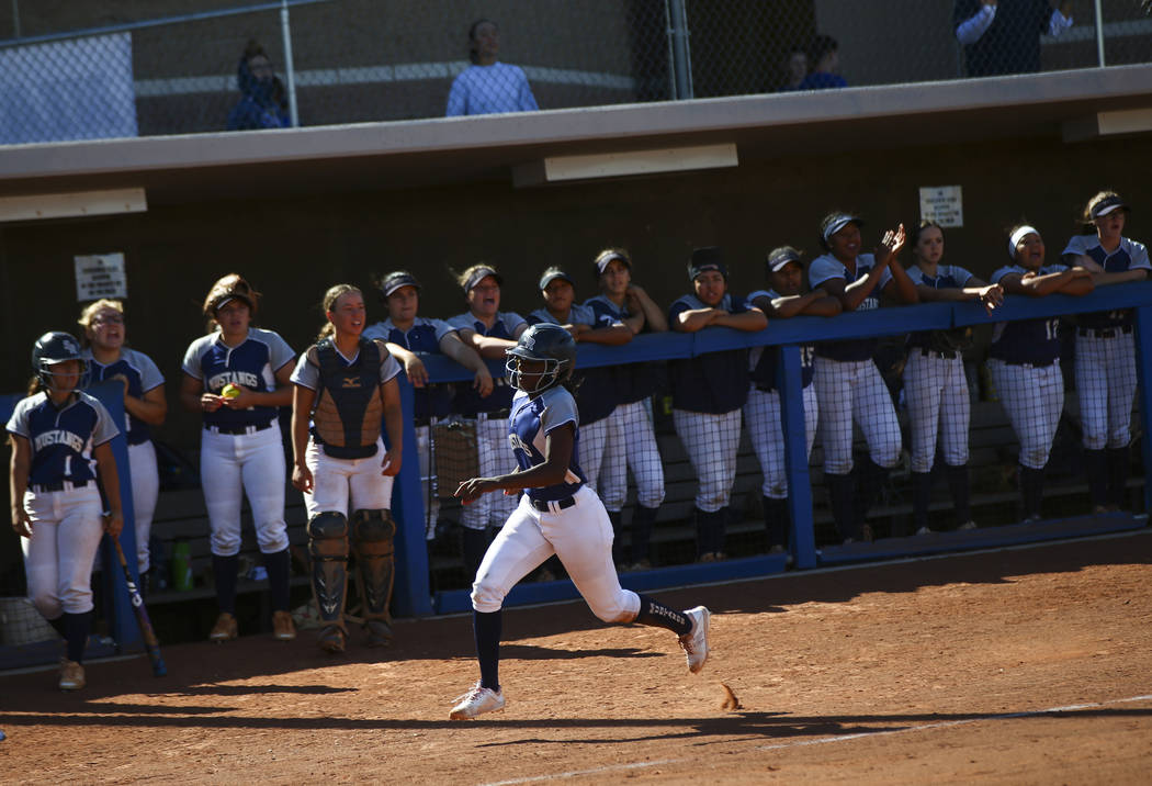 Shadow Ridge's Jasmine Martin (8) heads to home plate to score a run against McQueen during the ...