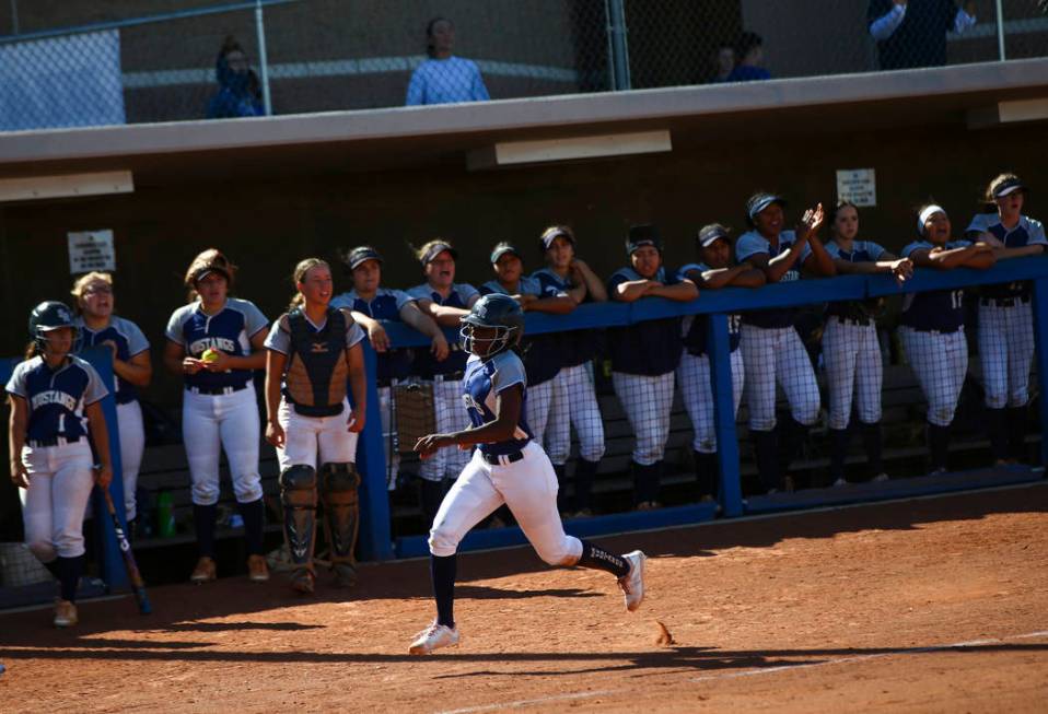 Shadow Ridge's Jasmine Martin (8) heads to home plate to score a run against McQueen during the ...