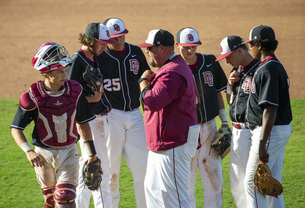 Desert Oasis' players come together on the mound with their coach versus Reno during their Clas ...