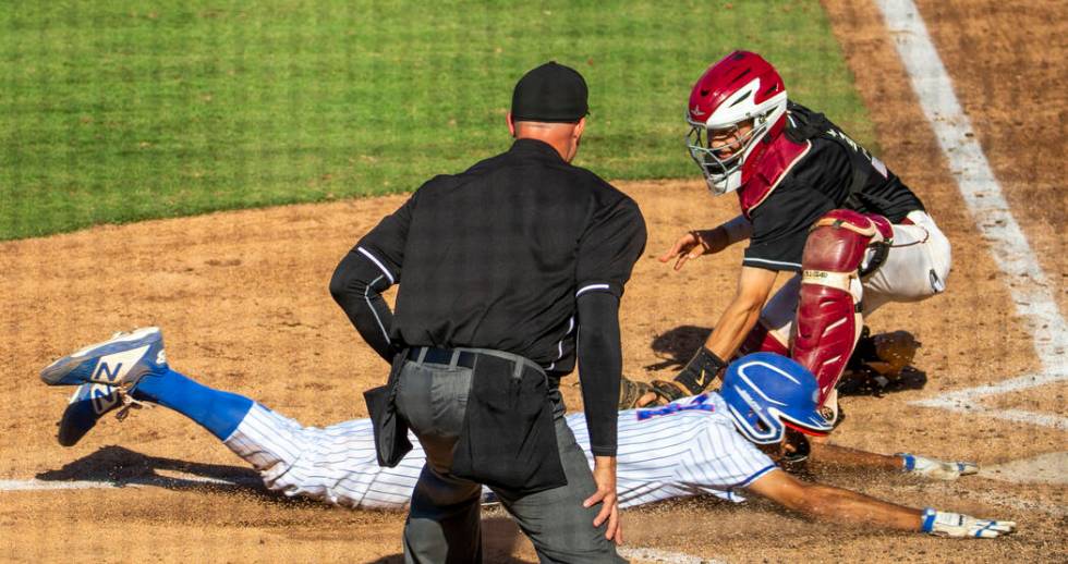 Reno's Skylar Hales (24) just beats the tag at home plate by Desert Oasis catcher Parker Schmid ...