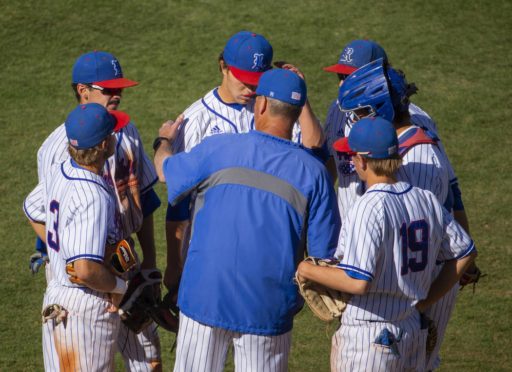 Reno head coach Pete Savage counsels his infielders versus Desert Oasis during their Class 4A s ...