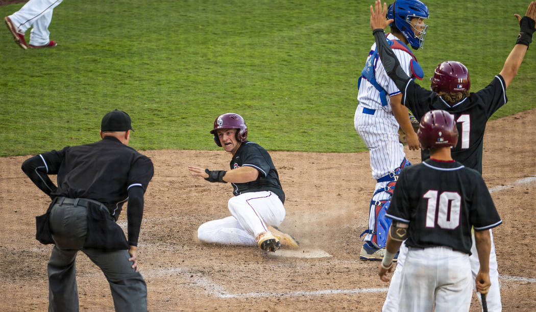 Desert Oasis' Colton Zobrist (7) slides in safely for another run over Reno during their Class ...