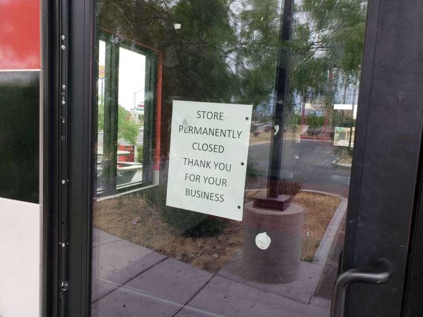 A sign on the door of a Checkers restaurant on Rancho Drive near U.S. Highway 95, alerting cust ...