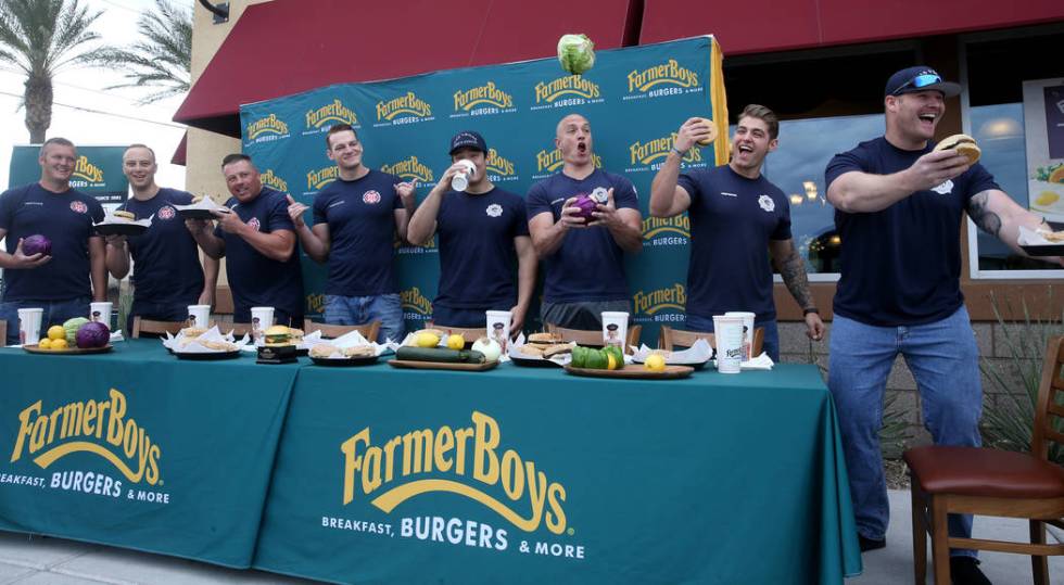 Clark County and Las Vegas firefighters prepare for a burger eating competition at Farmer Boys ...