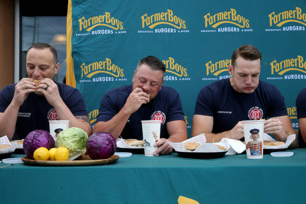 Clark County firefighters from left, Shawn Goldberg, Erik Oliver and Shane Salmon compete again ...